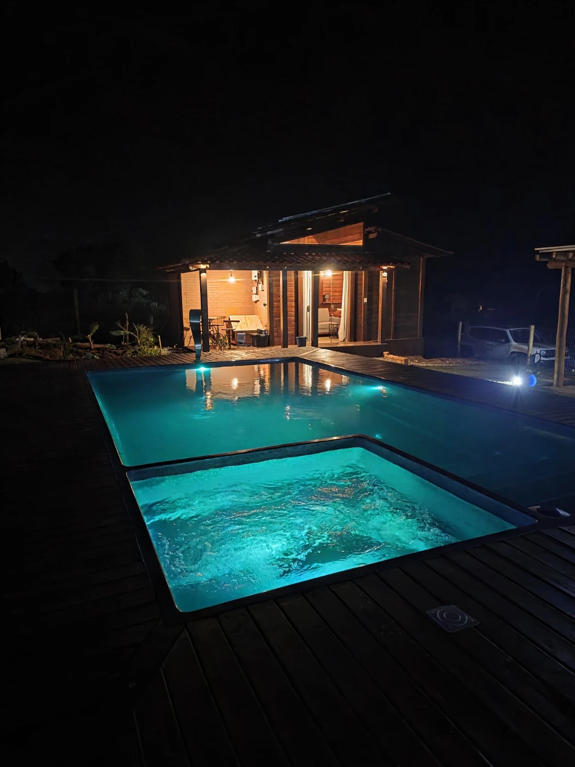 Spa e piscina iluminados do Ville Signature à noite